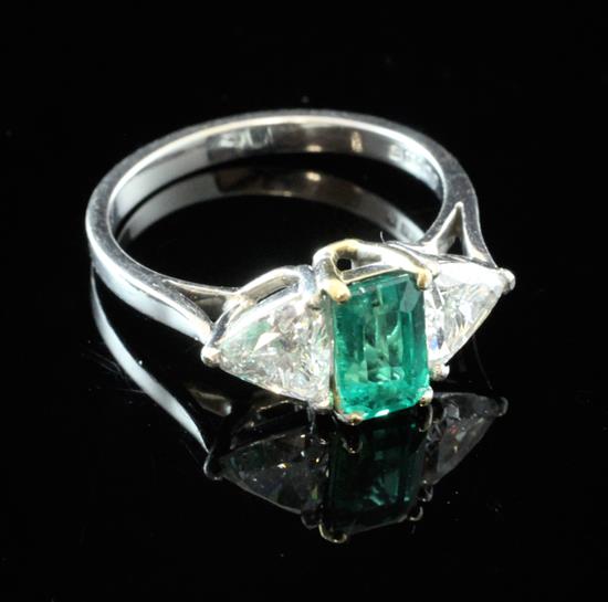 An 18ct white gold, emerald and diamond three stone ring, size N.